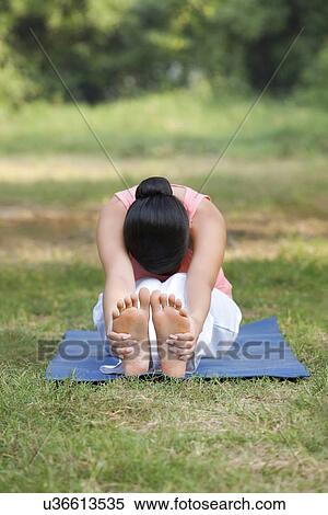 Woman stretching in lawn View Large Photo Image Stock Photography - Woman stretching in lawn . Fotosearch