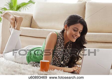 Woman surfing the net on a laptop View Large Photo Image Stock Photo - Woman surfing the net on a laptop. Fotosearch