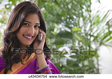Picture - Woman talking on a mobile phone . Fotosearch