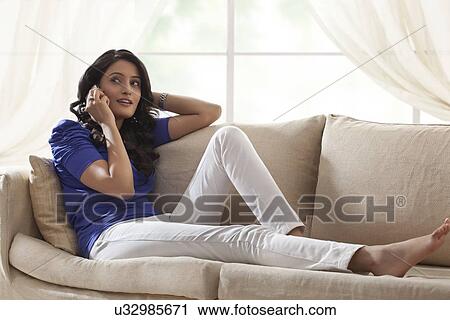 Woman talking on a mobile phone View Large Photo Image Stock Image - Woman talking on a mobile phone. Fotosearch
