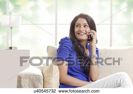 Woman talking on a mobile phone View Large Photo Image Stock Image - Woman talking on a mobile phone. Fotosearch