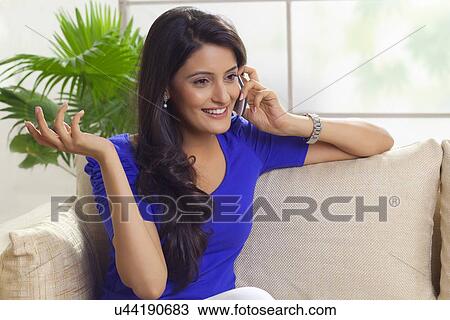 Woman talking on a mobile phone View Large Photo Image Stock Image - Woman talking on a mobile phone. Fotosearch