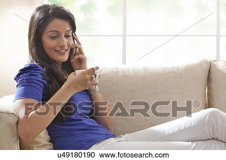 Woman talking on a mobile phone View Large Photo Image Stock Image - Woman talking on a mobile phone. Fotosearch