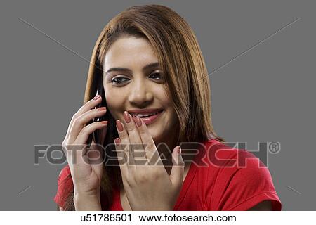 Stock Image - Woman talking on a mobile phone . Fotosearch