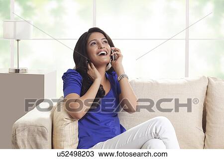 Woman talking on a mobile phone View Large Photo Image Stock Image - Woman talking on a mobile phone. Fotosearch