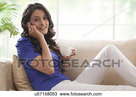 Stock Image - Woman talking on a mobile phone. Fotosearch