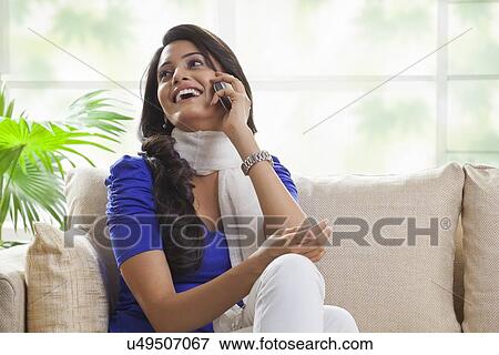 Woman talking on a mobile phone View Large Photo Image Stock Photo - Woman talking on a mobile phone. Fotosearch