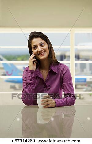 Woman talking on a mobile phone View Large Photo Image Stock Photo - Woman talking on a mobile phone . Fotosearch