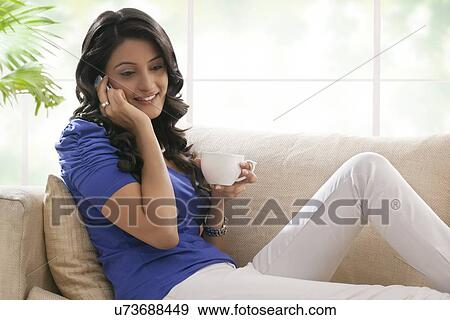Woman talking on a mobile phone View Large Photo Image Stock Photo - Woman talking on a mobile phone. Fotosearch