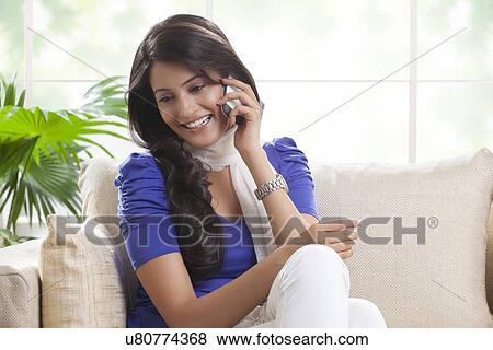 Woman talking on a mobile phone View Large Photo Image Stock Photo - Woman talking on a mobile phone. Fotosearch