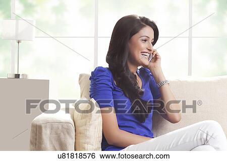 Woman talking on a mobile phone View Large Photo Image Stock Photograph - Woman talking on a mobile phone. Fotosearch
