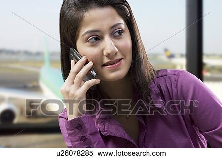 Stock Photography - Woman talking on a mobile phone . Fotosearch