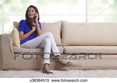 Woman talking on a mobile phone View Large Photo Image Stock Photography - Woman talking on a mobile phone. Fotosearch