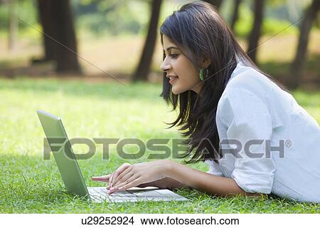 Woman using laptop on campus View Large Photo Image Picture - Woman using laptop on campus . Fotosearch