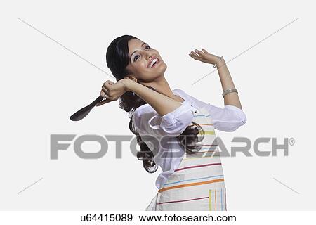 Stock Photo - Woman with a cooking utensil rejoicing. Fotosearch