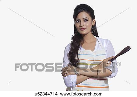 Woman with a cooking utensil thinking View Large Photo Image Picture - Woman with a cooking utensil thinking. Fotosearch