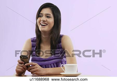 Stock Photo - Woman with a mobile phone . Fotosearch
