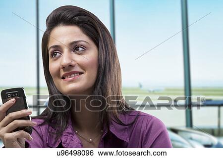 Stock Photograph - Woman with a mobile phone . Fotosearch