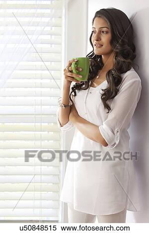 Woman with a mug of tea thinking View Large Photo Image Stock Photography - Woman with a mug of tea thinking. Fotosearch