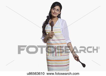 Stock Image - Woman with cooking utensils. Fotosearch