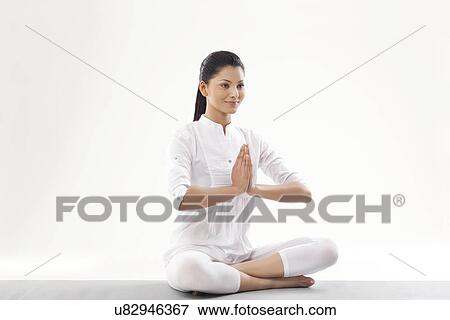 Stock Photo - Woman with hands joint looking away . Fotosearch