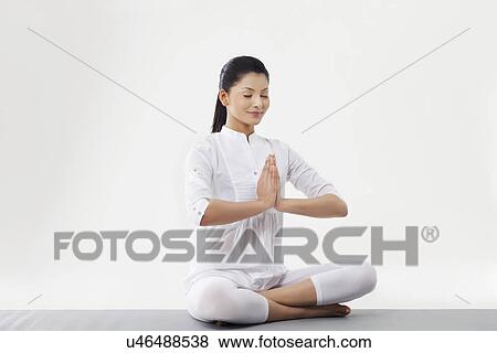 Stock Photo - Woman with hands joint meditating . Fotosearch