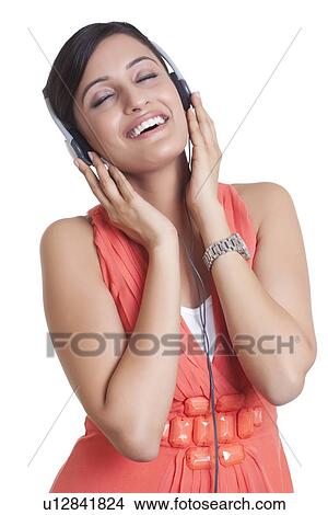 Picture - Woman with headphones listening to music. Fotosearch
