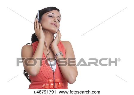 Woman with headphones listening to music View Large Photo Image Stock Image - Woman with headphones listening to music. Fotosearch