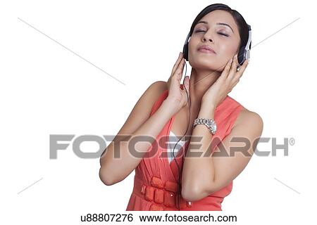 Woman with headphones listening to music View Large Photo Image Stock Photograph - Woman with headphones listening to music. Fotosearch
