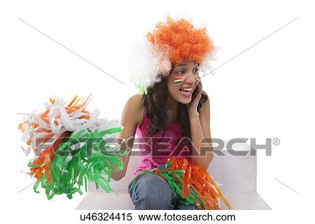 Stock Photography - Woman with pom-pons talking on a mobile phone . Fotosearch
