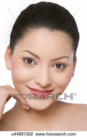 Woman with pretty smile touching her face View Large Photo Image Stock Image - Woman with pretty smile touching her face . Fotosearch
