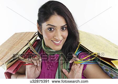 Stock Image - Woman with shopping bags . Fotosearch