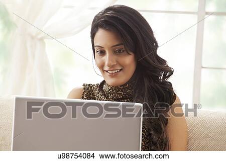 Woman working on a laptop View Large Photo Image Picture - Woman working on a laptop. Fotosearch