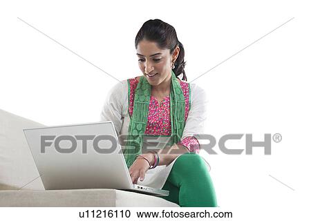 Woman working on a laptop View Large Photo Image Stock Image - Woman working on a laptop . Fotosearch