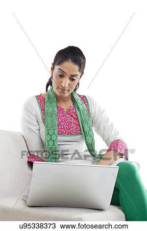 Stock Image - Woman working on a laptop . Fotosearch