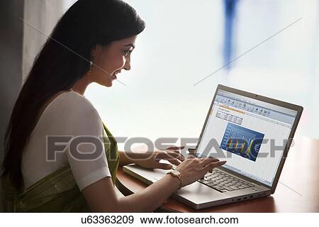 Stock Photo - Woman working on a laptop . Fotosearch