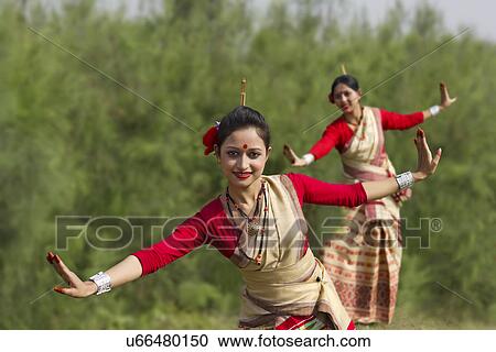 Stock Image - Women performing Bihu dance . Fotosearch