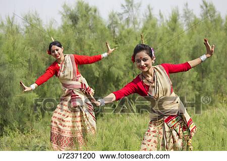 Stock Image - Women performing Bihu dance . Fotosearch