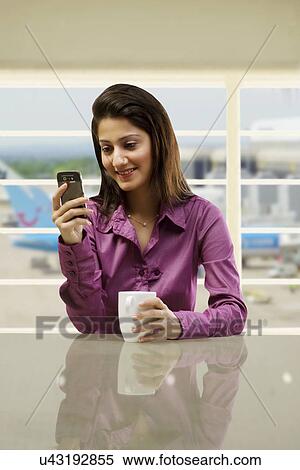 Women reading a message on a mobile phone View Large Photo Image Stock Photography - Women reading a message on a mobile phone . Fotosearch