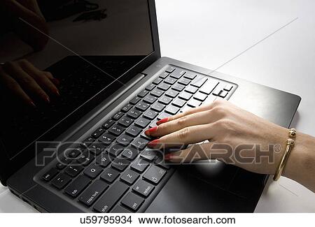 Working on a Laptop View Large Photo Image Picture - Working on a Laptop . Fotosearch