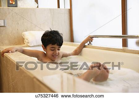 Young boy having a bubble bath View Large Photo Image Stock Photograph - Young boy having a bubble bath . Fotosearch