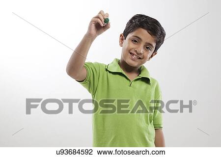 Stock Image - Young boy holding a marker pen . Fotosearch