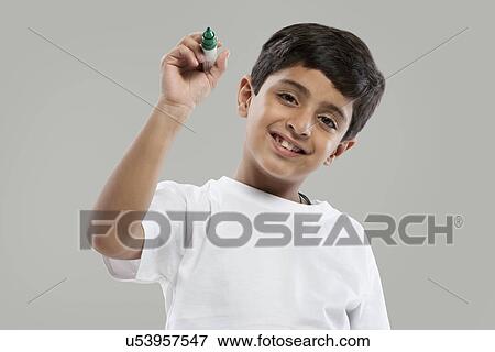Stock Photo - Young boy holding a marker pen . Fotosearch