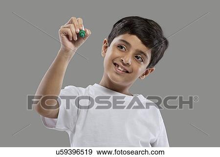 Stock Photo - Young boy holding a marker pen . Fotosearch