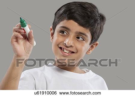 Young boy holding a marker pen View Large Photo Image Stock Photograph - Young boy holding a marker pen . Fotosearch