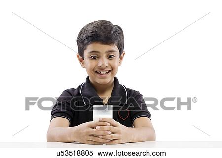 Young boy looking at a glass of milk View Large Photo Image Stock Photography - Young boy looking at a glass of milk . Fotosearch