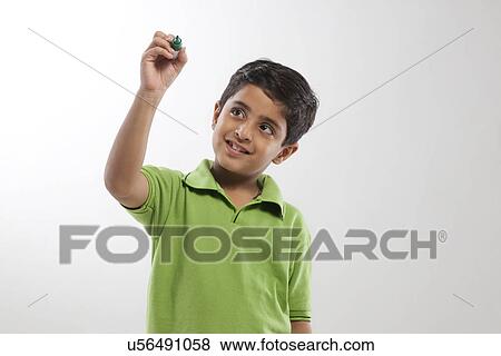 Young boy pretending to write with a marker pen View Large Photo Image Stock Photo - Young boy pretending to write with a marker pen . Fotosearch