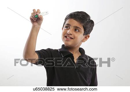 Young boy pretending to write with a marker pen View Large Photo Image Stock Photography - Young boy pretending to write with a marker pen . Fotosearch
