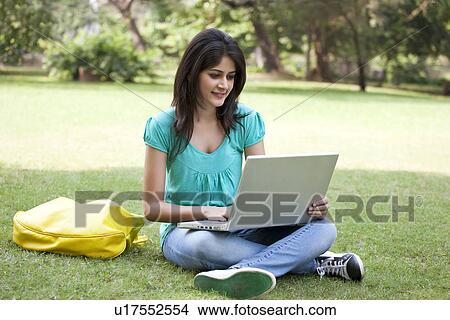 Young college student surfing net View Large Photo Image Picture - Young college student surfing net . Fotosearch