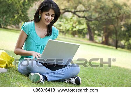 Young college student using laptop View Large Photo Image Stock Photo - Young college student using laptop . Fotosearch